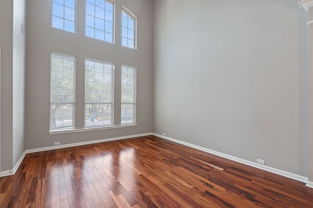 9013 Lantana Way, Austin, TX 78749 - empty room with healthy amount of natural light, baseboards, and dark wood-type flooring