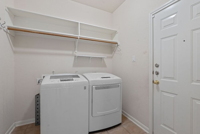 9013 Lantana Way, Austin, TX 78749 - clothes washing area featuring washer and clothes dryer, light tile patterned flooring, and baseboards
