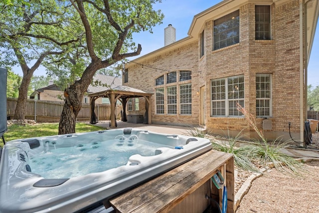 9013 Lantana Way, Austin, TX 78749 - view of patio / terrace with an outdoor hot tub, a gazebo, and fence