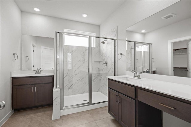 115 Paul Pena Dr, San Marcos, TX 78666 - full bathroom with a marble finish shower, two vanities, a spacious closet, and recessed lighting