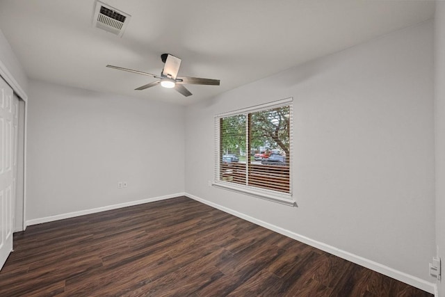 7516 Marble Crest Dr, Austin, TX 78747 - unfurnished bedroom with a closet, baseboards, and dark wood-style floors