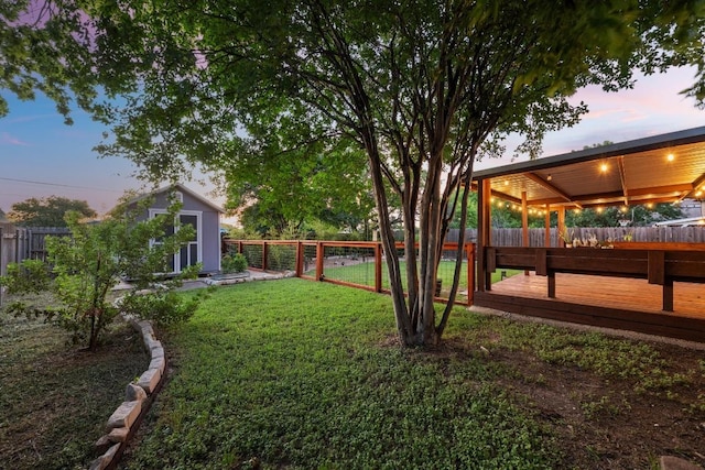 7516 Marble Crest Dr, Austin, TX 78747 - view of yard featuring a wooden deck, an outdoor structure, and a storage unit