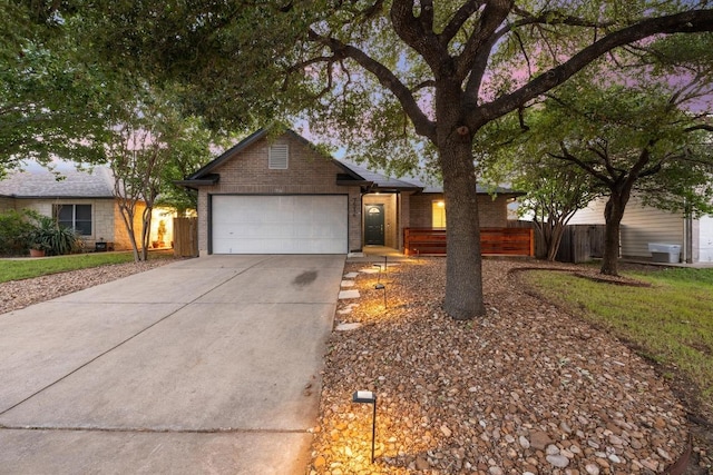 7516 Marble Crest Dr, Austin, TX 78747 - single story home with brick siding, driveway, a garage, and fence