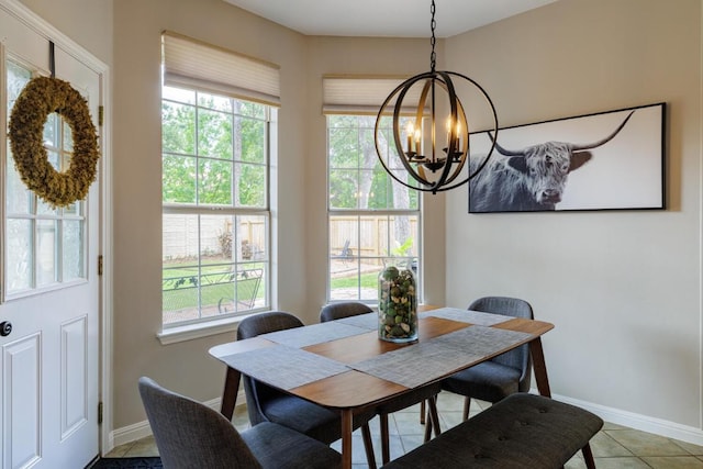 2113 Spring Hollow Path, Round Rock, TX 78681 - dining area featuring a chandelier, baseboards, and light tile patterned floors