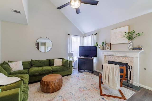 2113 Spring Hollow Path, Round Rock, TX 78681 - living room with high vaulted ceiling, wood finished floors, ceiling fan, baseboards, and a tiled fireplace