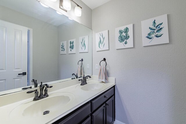 2113 Spring Hollow Path, Round Rock, TX 78681 - bathroom featuring double vanity and a textured wall