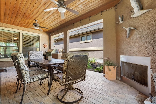 4332 Teravista Club Dr Unit 69, Round Rock, TX 78665 - view of patio featuring exterior fireplace, outdoor dining area, and a ceiling fan