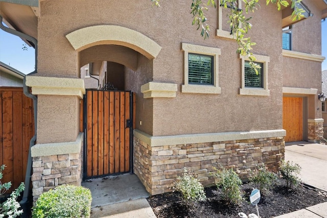 4332 Teravista Club Dr Unit 69, Round Rock, TX 78665 - doorway to property featuring stucco siding, a gate, and stone siding