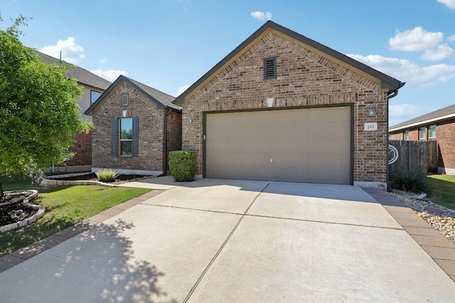 212 Mauldin St, Georgetown, TX 78628 - view of front facade featuring brick siding, concrete driveway, and a garage