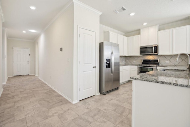212 Mauldin St, Georgetown, TX 78628 - kitchen featuring appliances with stainless steel finishes, a sink, light stone countertops, ornamental molding, and tasteful backsplash