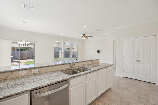 212 Mauldin St, Georgetown, TX 78628 - kitchen with dishwasher, a sink, crown molding, white cabinetry, and hanging light fixtures