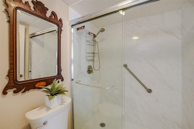 full bathroom featuring a marble finish shower and toilet