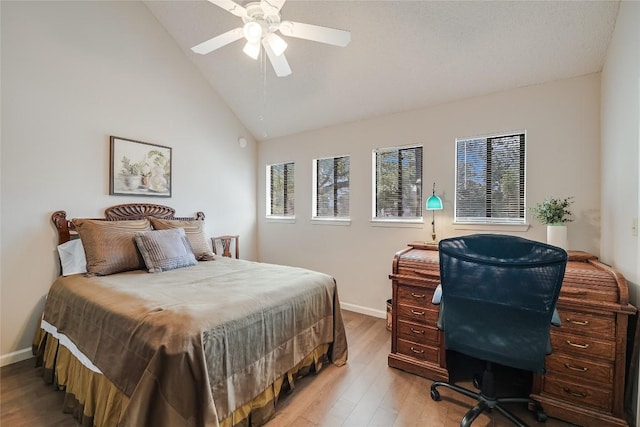 bedroom featuring light wood-style flooring, baseboards, high vaulted ceiling, and ceiling fan