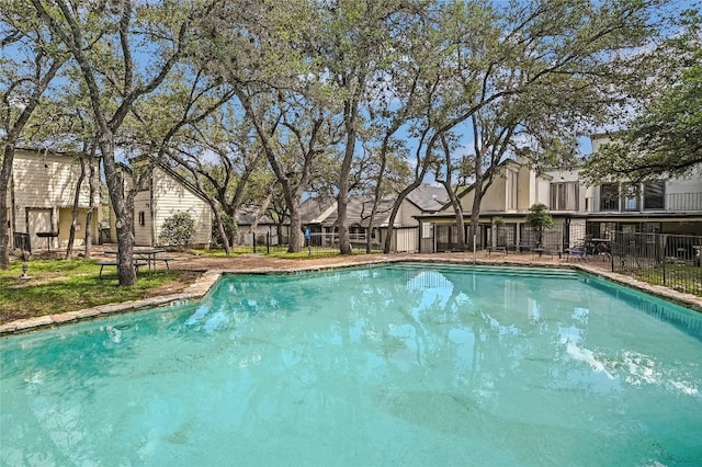 view of swimming pool with fence