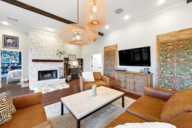 living area with wood finished floors, ornamental molding, a large fireplace, and recessed lighting