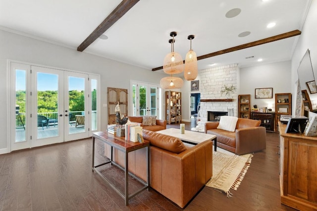 living area featuring french doors, dark wood-style floors, beamed ceiling, a large fireplace, and recessed lighting