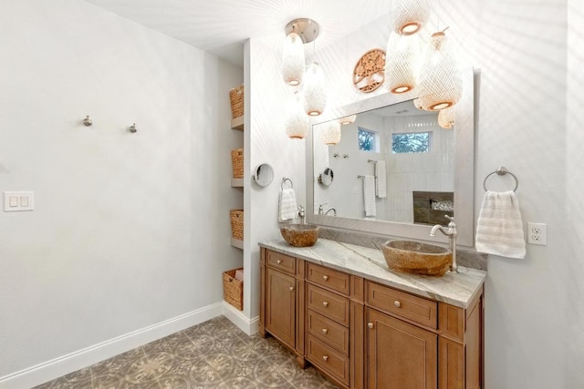 bathroom with baseboards, vanity, and tile patterned floors