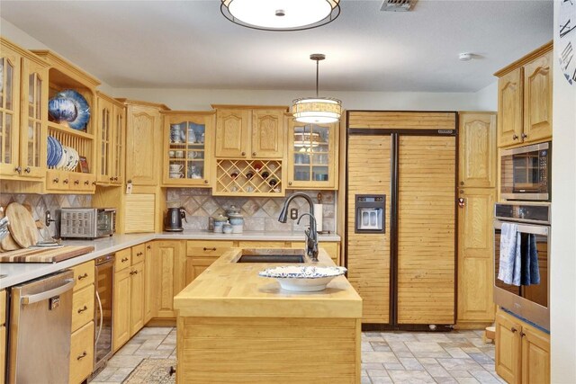 240 2 Mile Ln, Smithville, TX 78957 - kitchen with built in appliances, a sink, butcher block countertops, stone tile flooring, and backsplash