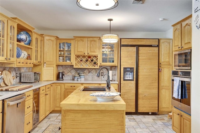 240 2 Mile Ln, Smithville, TX 78957 - kitchen with appliances with stainless steel finishes, a sink, butcher block countertops, stone tile floors, and decorative backsplash