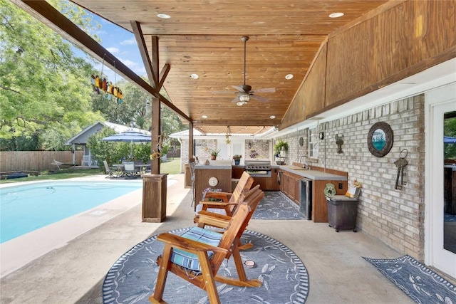 240 2 Mile Ln, Smithville, TX 78957 - view of patio / terrace with exterior kitchen, fence, ceiling fan, a sink, and a grill