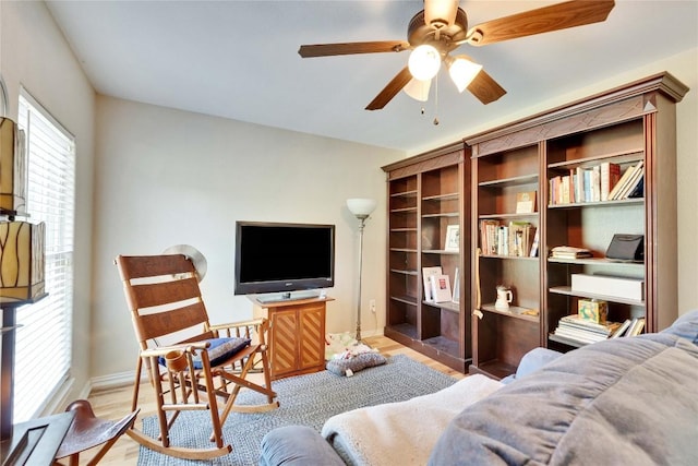 240 2 Mile Ln, Smithville, TX 78957 - living area with wood finished floors, a ceiling fan, and baseboards