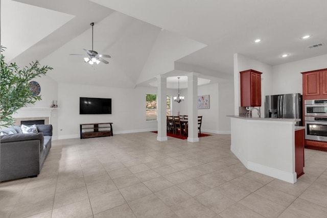 living room featuring decorative columns, recessed lighting, light tile patterned floors, baseboards, and a ceiling fan