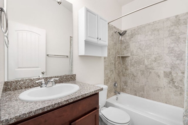 bathroom with tub / shower combination, vanity, and toilet