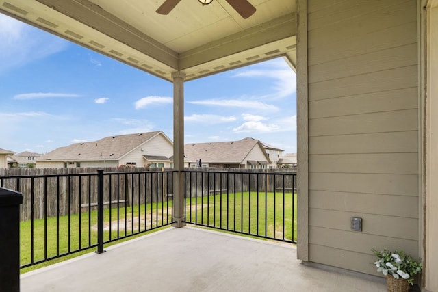 balcony featuring ceiling fan, a residential view, and a patio