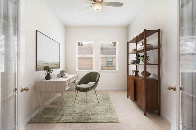 office space with ceiling fan, light carpet, and baseboards