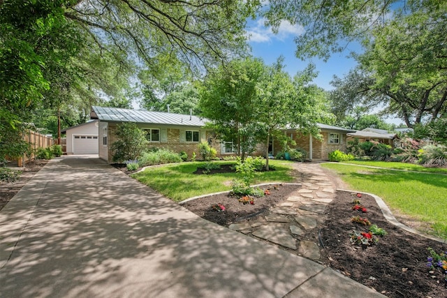 3000 Greenlawn Pkwy, Austin, TX 78757 - single story home featuring concrete driveway, brick siding, and metal roof