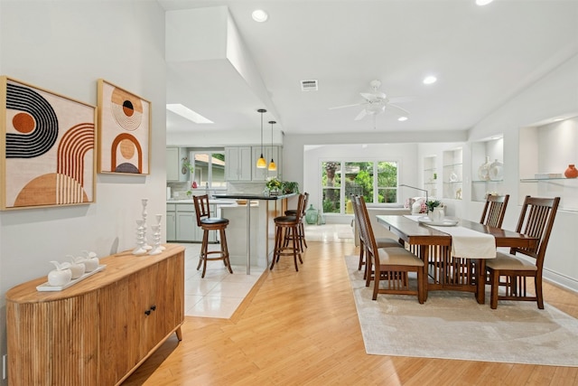 3000 Greenlawn Pkwy, Austin, TX 78757 - dining room featuring light wood-style floors, a ceiling fan, recessed lighting, a skylight, and lofted ceiling