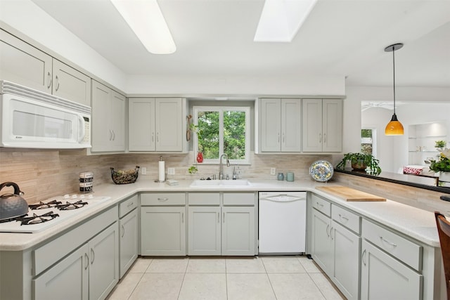 3000 Greenlawn Pkwy, Austin, TX 78757 - kitchen featuring white appliances, a sink, healthy amount of natural light, and backsplash
