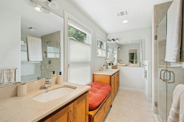 3000 Greenlawn Pkwy, Austin, TX 78757 - bathroom featuring healthy amount of natural light, two vanities, a stall shower, and tile patterned flooring