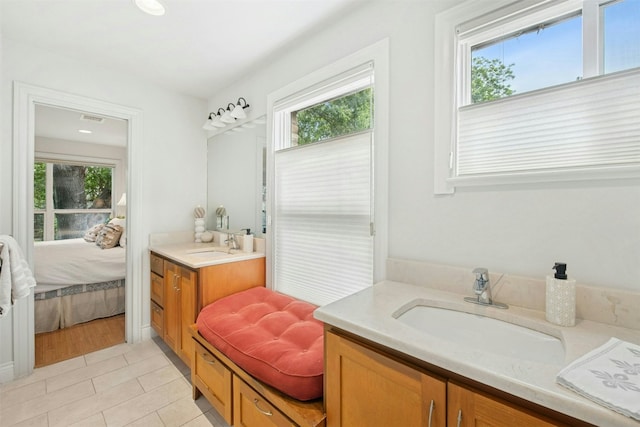 3000 Greenlawn Pkwy, Austin, TX 78757 - ensuite bathroom featuring vanity, plenty of natural light, and tile patterned flooring