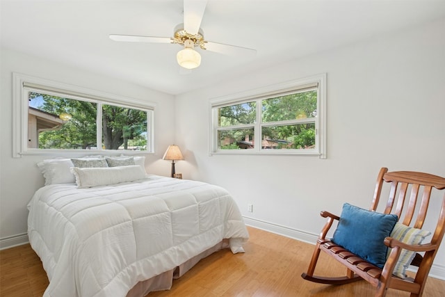 3000 Greenlawn Pkwy, Austin, TX 78757 - bedroom with light wood-style flooring, baseboards, and ceiling fan