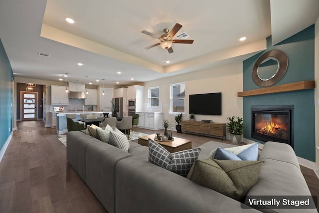159 Nodena Dr, Dripping Springs, TX 78620 - living area with dark wood-style flooring, recessed lighting, baseboards, a ceiling fan, and a raised ceiling