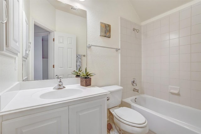 bathroom with toilet, shower / washtub combination, vaulted ceiling, and vanity
