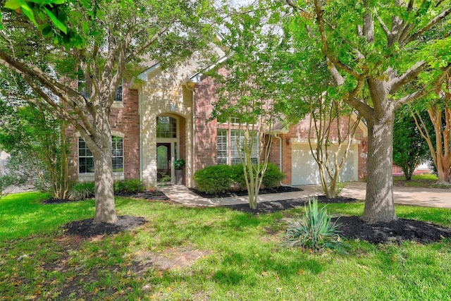 view of front facade with brick siding, an attached garage, driveway, and a front lawn