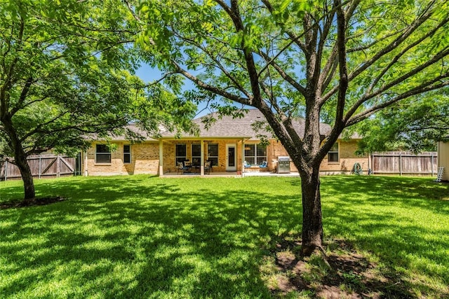 rear view of house with brick siding and a patio area