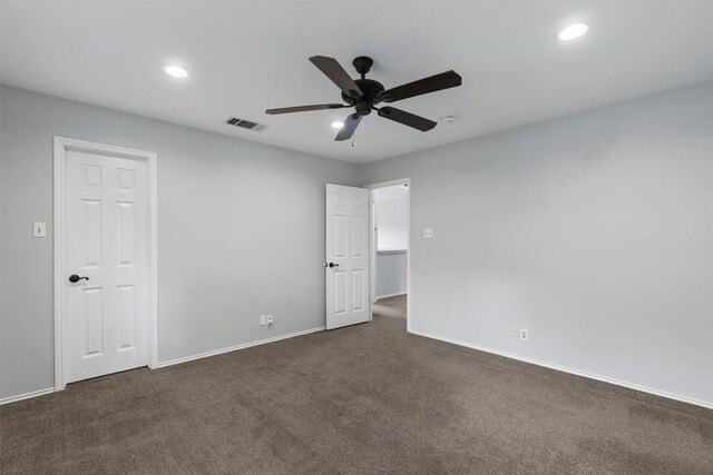 unfurnished bedroom with dark colored carpet, recessed lighting, baseboards, and a ceiling fan