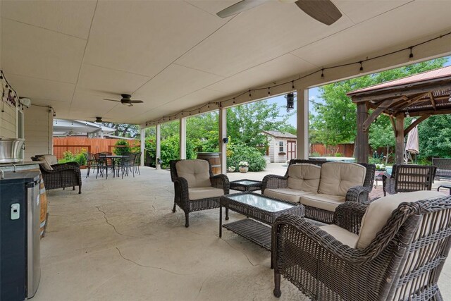 view of patio / terrace featuring outdoor dining space, ceiling fan, outdoor lounge area, and fence