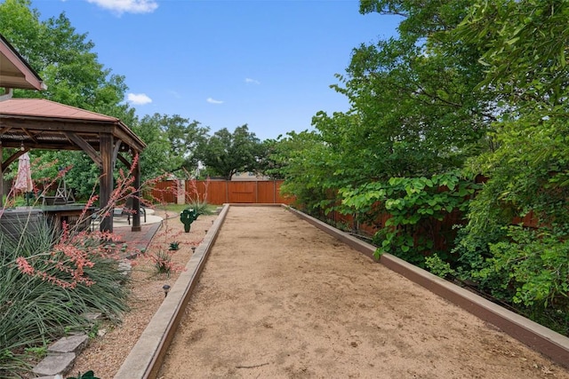 view of yard featuring a game area, a gazebo, and fence