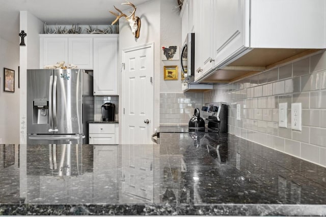 1413 Coffee Tree Dr, New Braunfels, TX 78130 - kitchen featuring stainless steel appliances, white cabinetry, backsplash, and dark stone counters