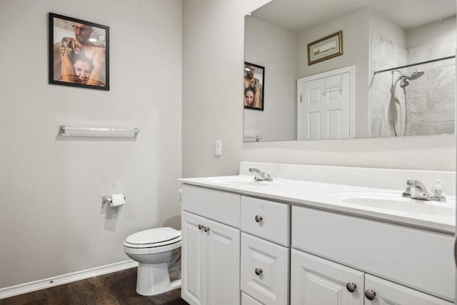 1413 Coffee Tree Dr, New Braunfels, TX 78130 - full bathroom with toilet, baseboards, wood finished floors, tiled shower, and double vanity