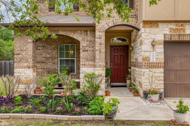 view of exterior entry featuring brick siding and stone siding