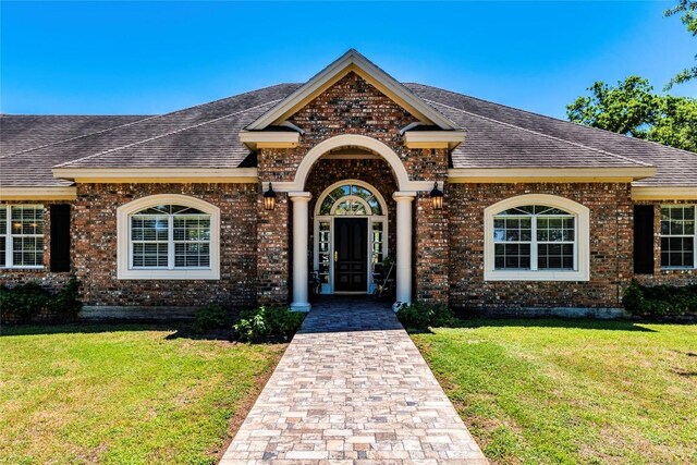 17270 Fm 112, Thrall, TX 76578 - view of front of house with a shingled roof, a front lawn, and brick siding