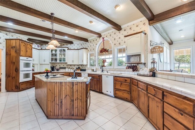 17270 Fm 112, Thrall, TX 76578 - kitchen with white appliances, beam ceiling, decorative backsplash, light countertops, and wallpapered walls
