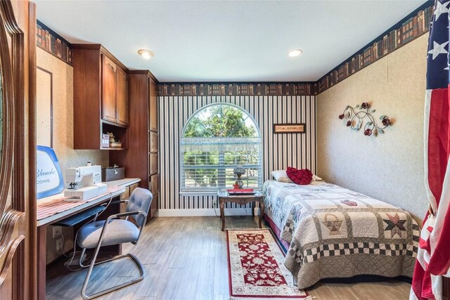 17270 Fm 112, Thrall, TX 76578 - bedroom with light wood-style flooring, an office area, and wallpapered walls