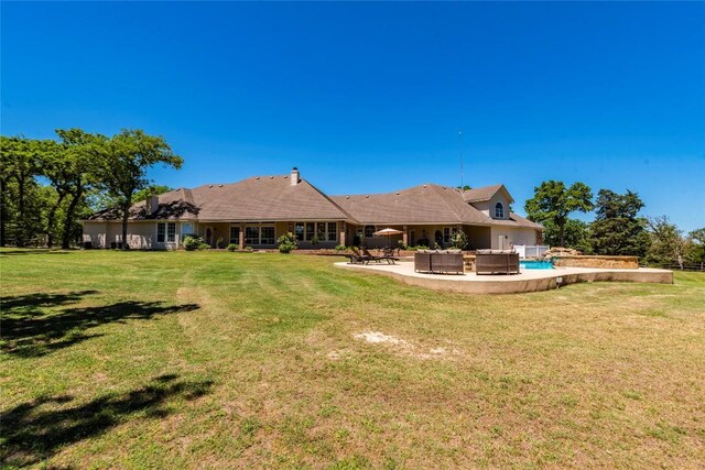 17270 Fm 112, Thrall, TX 76578 - back of property with a patio, a lawn, an outdoor living space, and a swimming pool
