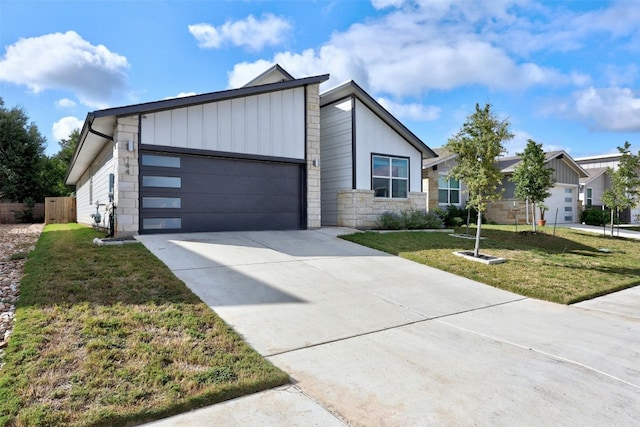 144 Shawii Pass, Leander, TX 78641 - view of front of property with stone siding, a garage, driveway, and a front lawn